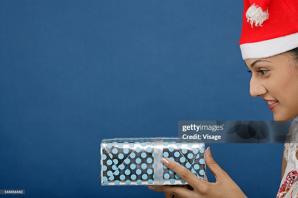 Close up of a young woman holding a gift box