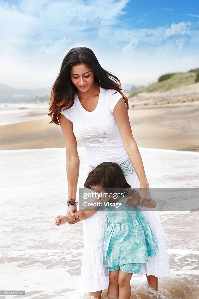 Young woman with her kid at a beach