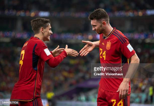 Gavi of Spain celebrates scoring the fifth goal with team mate Aymeric Laporte during the FIFA World Cup Qatar 2022 Group E match between Spain and...