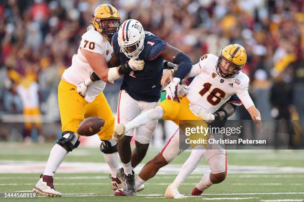 Quarterback Trenton Bourguet of the Arizona State Sun Devils fumbles the football from defensive lineman Jalen Harris of the Arizona Wildcats during...