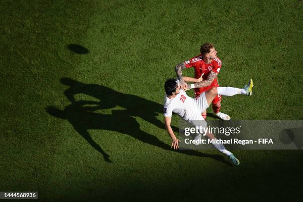 Joe Rodon of Wales battles for the ball the ball against Sardar Azmoun of IR Iran during the FIFA World Cup Qatar 2022 Group B match between Wales...