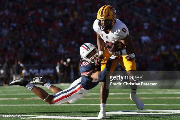 Wide receiver Charles Hall IV of the Arizona State Sun Devils makes a reception against cornerback Treydan Stukes of the Arizona Wildcats during the...