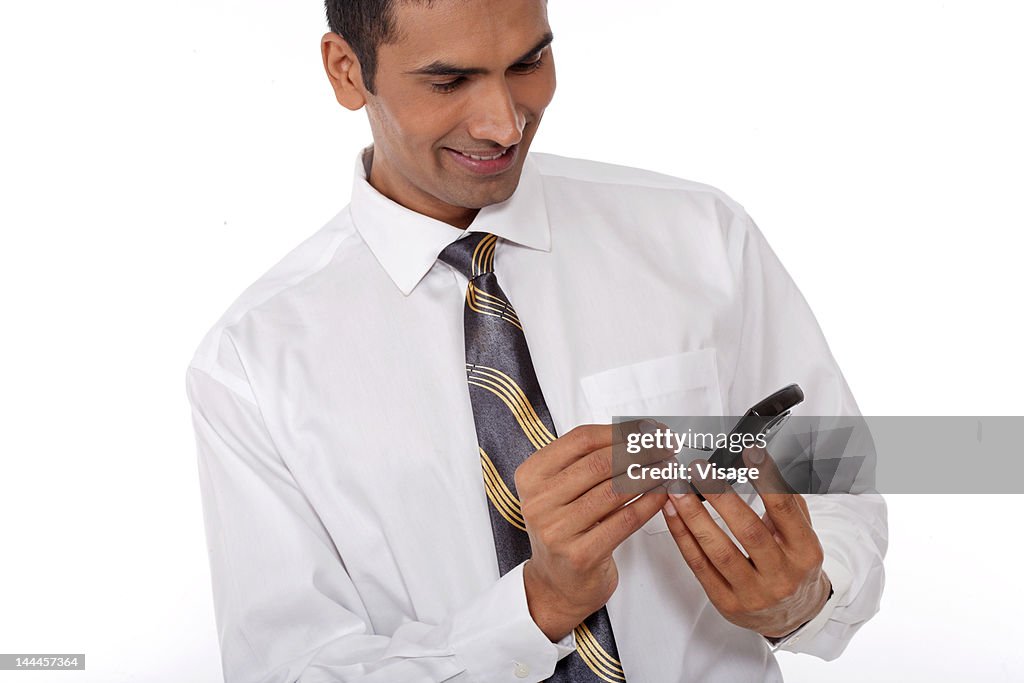 Young business man operating a mobile phone