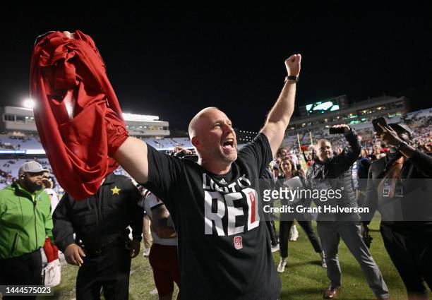 Head coach Dave Doeren of the North Carolina State Wolfpack celebrates as he leaves the field after a win against the North Carolina Tar Heels at...