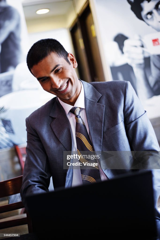 A young businessman working on a laptop