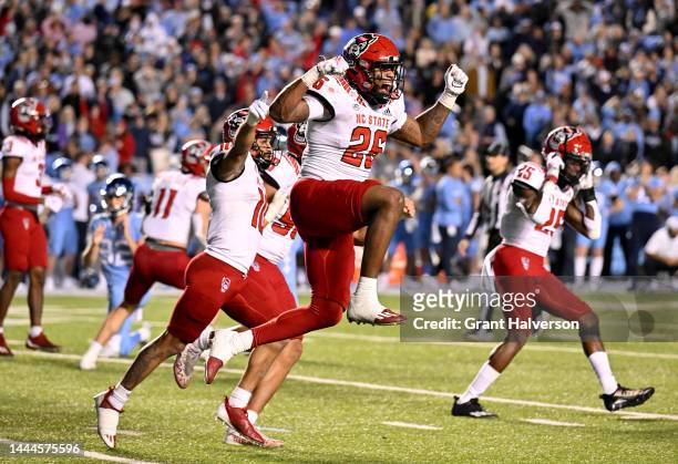 North Carolina State Wolfpack players celebrate after a missed field goal in overtime by the North Carolina Tar Heels at Kenan Memorial Stadium on...