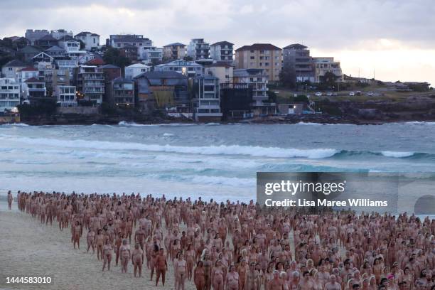 Members of the public pose at sunrise for photographic artist Spencer Tunick at Bondi Beach on November 26, 2022 in Sydney, Australia. US artist and...