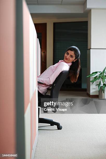 woman peeking out of a cubical - peeking cubicle stock pictures, royalty-free photos & images