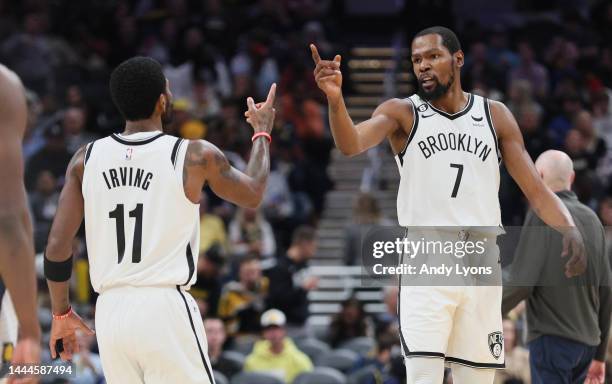 Kyrie Irving and Kevin Durant of the Brooklyn Nets celebrate during the first half of the game against the Indiana Pacer at Gainbridge Fieldhouse on...