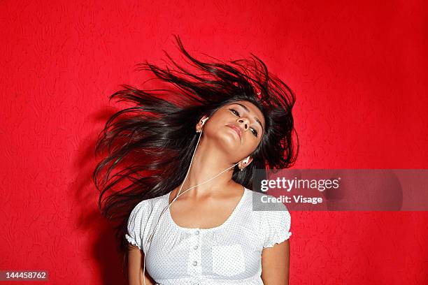 woman listening to music - headbanging stock pictures, royalty-free photos & images