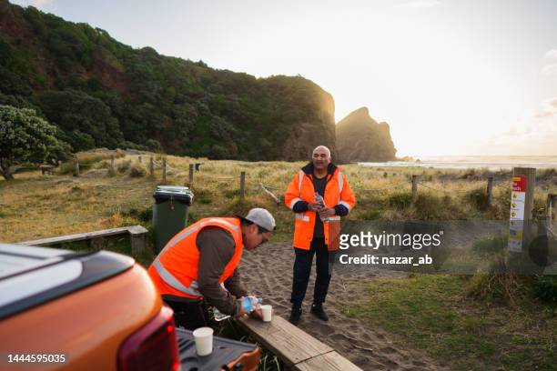 volunteers taking break during charity work. - new zealander stock pictures, royalty-free photos & images
