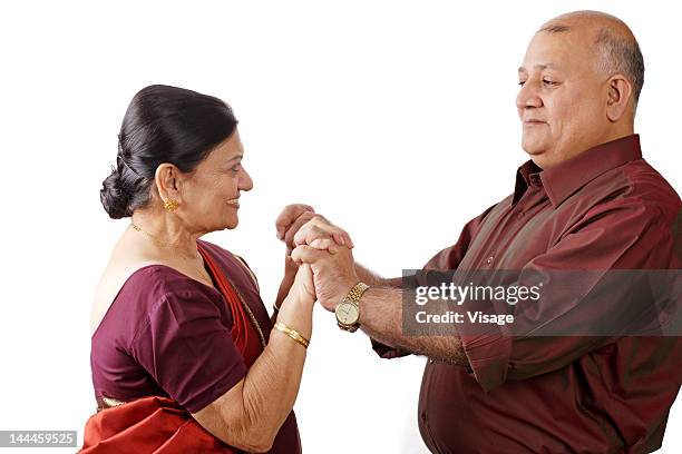 an old couple holding hands - sari isolated stock pictures, royalty-free photos & images
