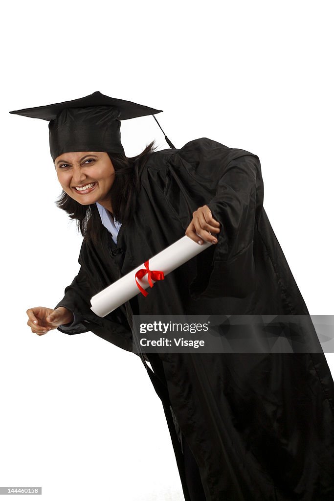 Portrait of a graduate holding diploma