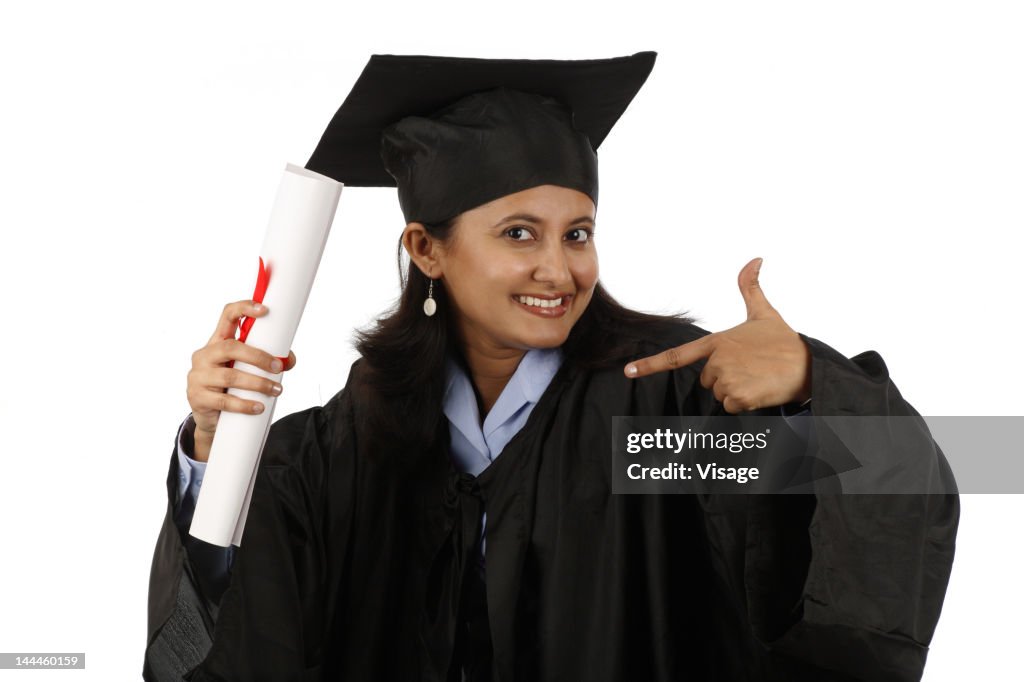 Portrait of a graduate holding diploma