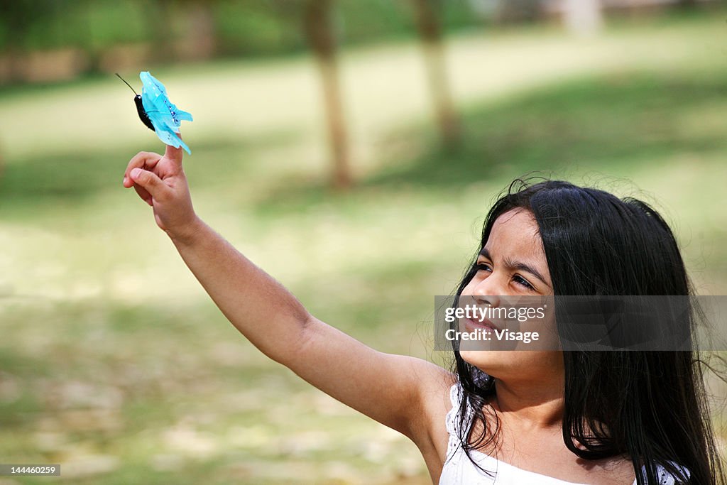 Girl playing with a butterfly