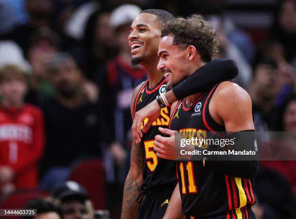 Dejounte Murray and Trae Young of the Atlanta Hawks smile following an altercation with Jalen Green and Jabari Smith Jr. #1 of the Houston Rockets...