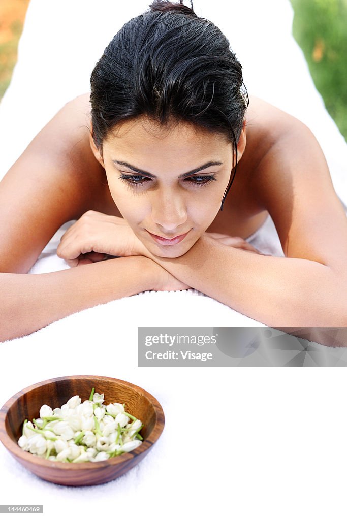 Young woman lying on massage table