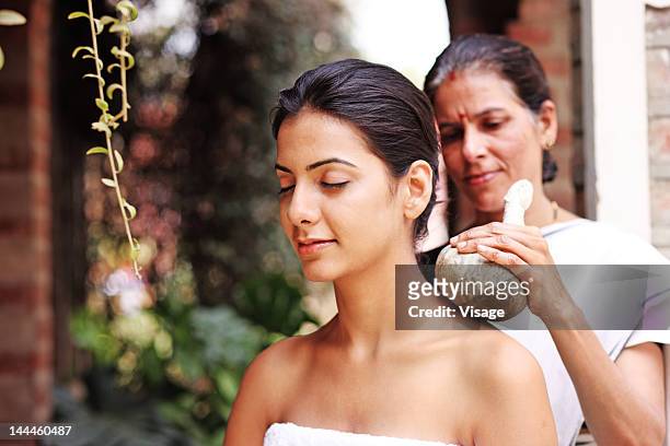 young woman getting a kizhi treatment - ayurveda kerala stock pictures, royalty-free photos & images