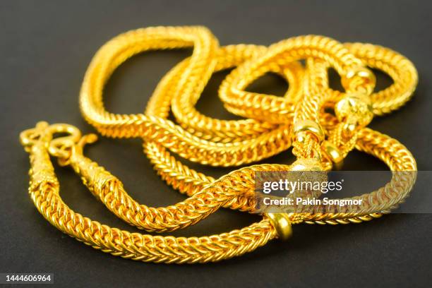 necklaces made of gold against a black background. - open collar stockfoto's en -beelden