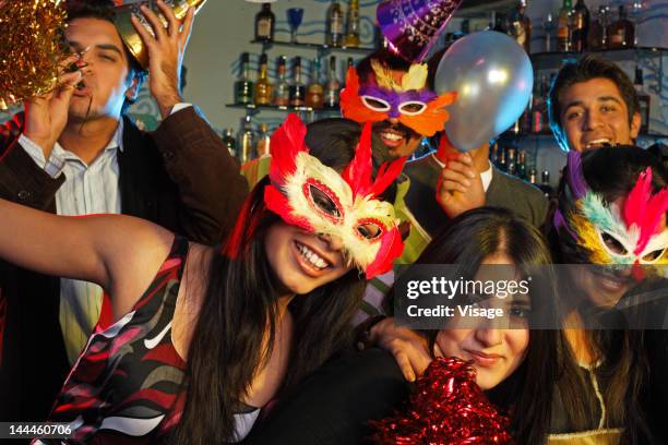 group of youngsters at a party celebrating - mask party stock pictures, royalty-free photos & images