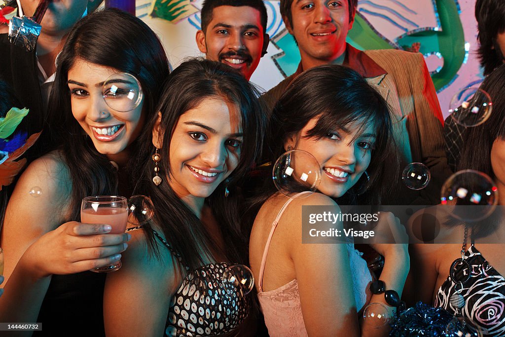 Portrait of men and women at a party
