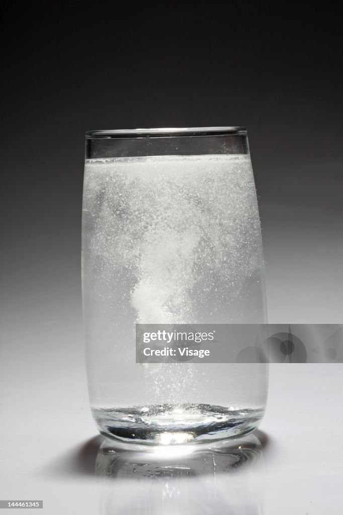 Effervescent tablet dissolving in a glass of water