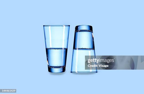 close up of two glasses - half stockfoto's en -beelden