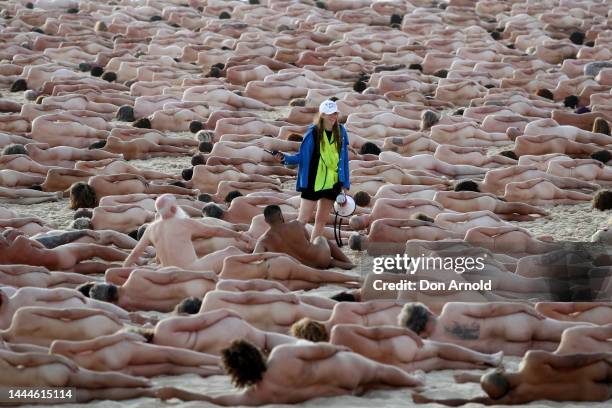 Crew member directs people into position at Bondi Beach on November 26, 2022 in Sydney, Australia. US artist and photographer Spencer Tunick created...