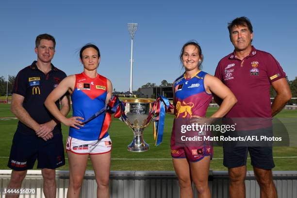 Mick Stinear and Daisy Pearce of the Demons and Craig Starcevich and Breanna Koenen of the Lions pose with the trophy after a press conference ahead...