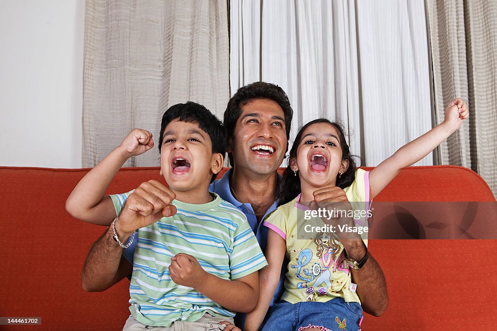 Young children rejoicing with their father