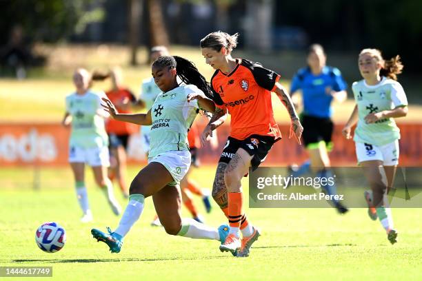 Kennedy Faulknor of Canberra and Larissa Crummer of the Roar compete for the ball during the round two A-League Women's match between the Brisbane...