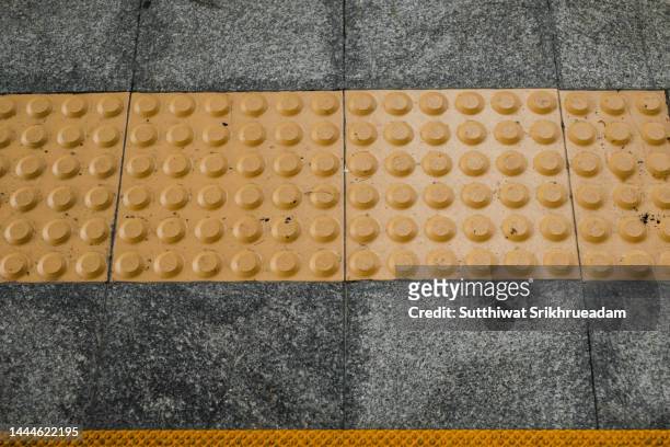 high angle view of warning block tactile braille block for safety of the blind - braille foto e immagini stock