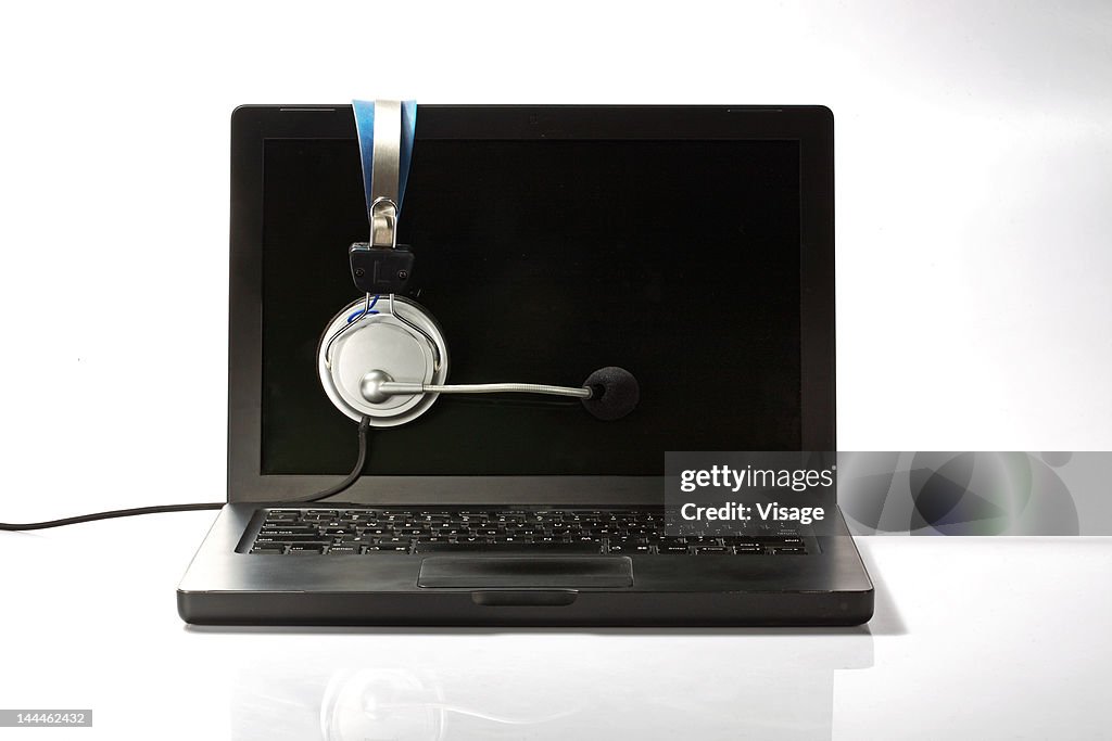 Close up of a laptop and a headphone