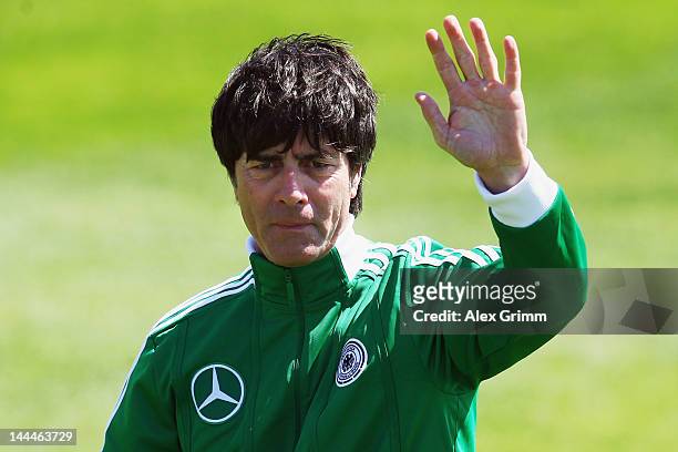 Head coach Joachim Loew waves to journalists after his arrival at a Germany training session at Campo Sportivo Comunale Andrea Dora on May 14, 2012...