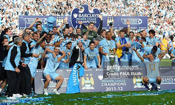 Manchester City's Belgian captain Vincent Kompany prepares to lift the Premier league trophy after their 3-2 victory over Queens Park Rangers in the...