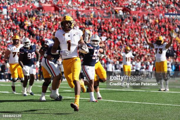 Running back Xazavian Valladay of the Arizona State Sun Devils scores a four-yard rushing touchdown against the Arizona Wildcats during the first...
