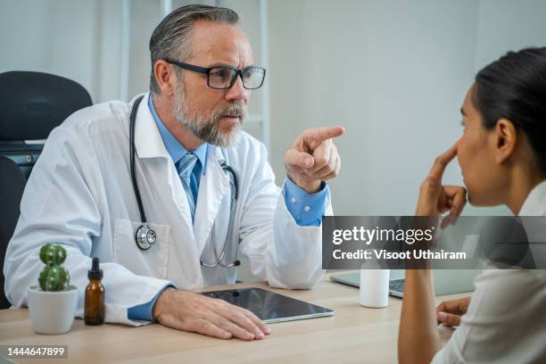 woman having her eyes examined by an eye doctor at clinic,doctor examining patient. - eye problems stock pictures, royalty-free photos & images