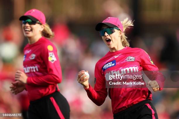 Maitlan Brown of the Sixers celebrates with her team after taking the catch for the wicket of Deandra Dottin of the Strikers only to have it...