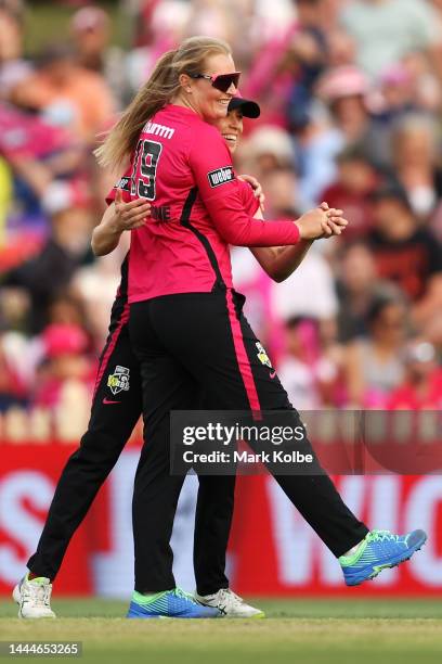 Sophie Ecclestone of the Sixers celebrates with Erin Burns of the Sixers taking the wicket of Bridget Patterson of the Strikers during the Women's...