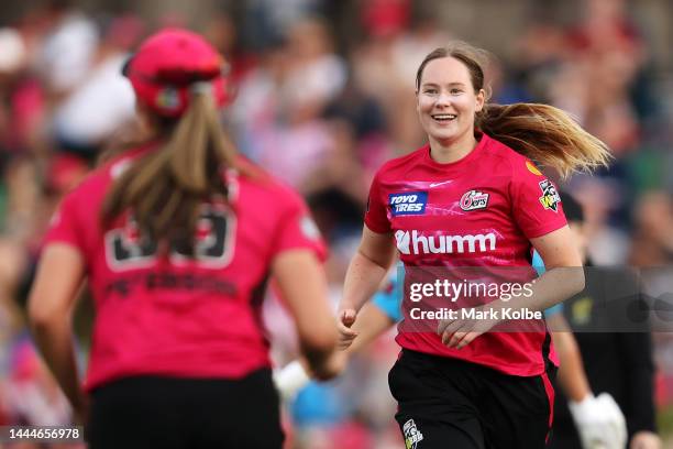 Lauren Cheatle of the Sixers celebrates with his team after taking the wicket of Madeline Penna of the Strikers during the Women's Big Bash League...