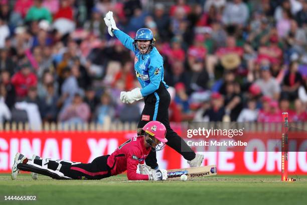 Tegan McPharlin of the Strikers successfully appeals for a stumping for the wicket of Erin Burns of the Sixers during the Women's Big Bash League...