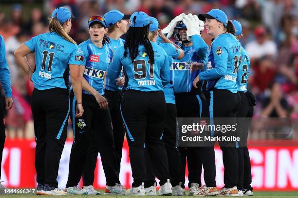 Tegan McPharlin of the Strikers celebrates with her team after a stumping for the wicket of Erin Burns of the Sixers during the Women's Big Bash...