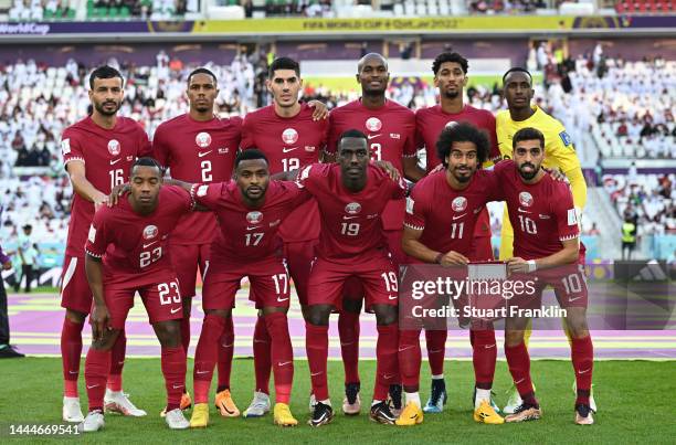Players of Qatar line up prior to kick off at the FIFA World Cup Qatar 2022 Group A match between Qatar and Senegal at Al Thumama Stadium on November...
