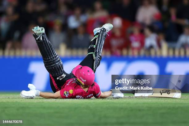 Nicole Bolton of the Sixers falls over as shebats during the Women's Big Bash League Final between the Sydney Sixers and the Adelaide Strikers at...