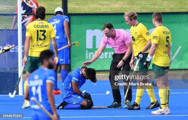 Amit Rohidas of India reacts to being hit by Blake Govers of the Kookaburras shooting for goal during game 1 of the International Hockey Test Series...