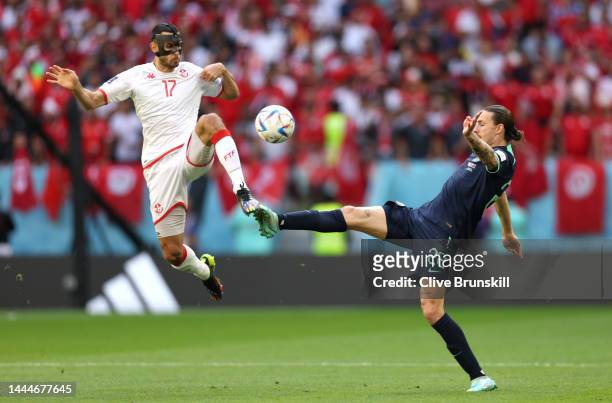 Ellyes Skhiri of Tunisia battles for possession with Jackson Irvine of Australia during the FIFA World Cup Qatar 2022 Group D match between Tunisia...