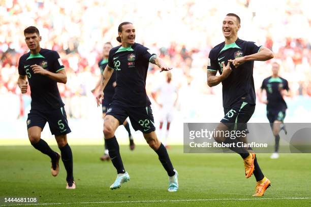 Mitchell Duke of Australia celebrates after scoring their team's first goal with their teammates Fran Karacic and Jackson Irvine during the FIFA...