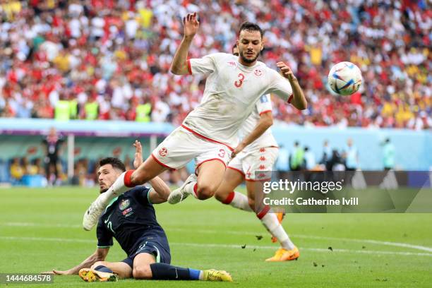 Montassar Talbi of Tunisia is tackled by Mathew Leckie of Australia during the FIFA World Cup Qatar 2022 Group D match between Tunisia and Australia...