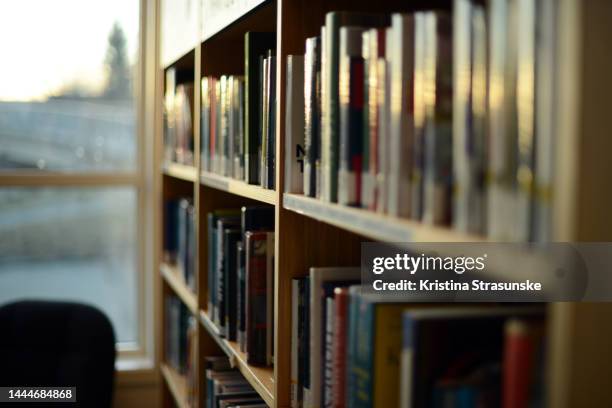 books in bookshelves - bookshelf stock pictures, royalty-free photos & images