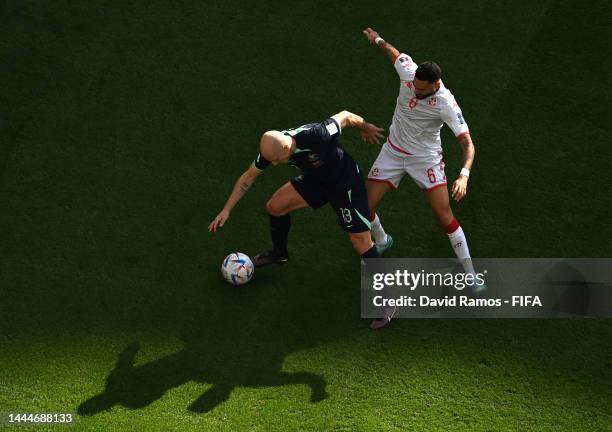 Aaron Mooy of Australia controls the ball under pressure of Dylan Bronn of Tunisia during the FIFA World Cup Qatar 2022 Group D match between Tunisia...